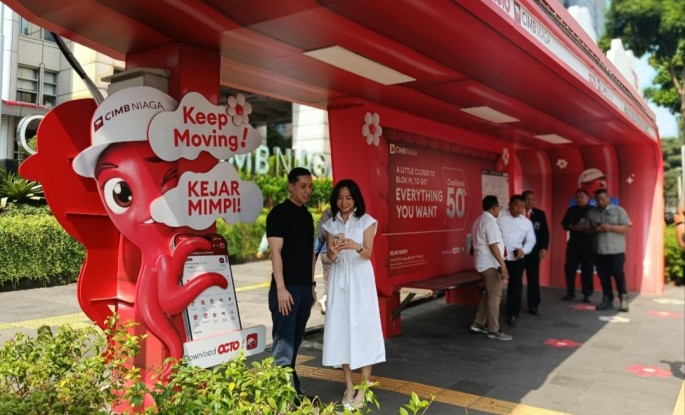 Nasabah membuka aplikasi di halte berlogo CIMB Niaga , di Jakarta. (Foto/Endang Muchtar/ECONOMICZONE) 